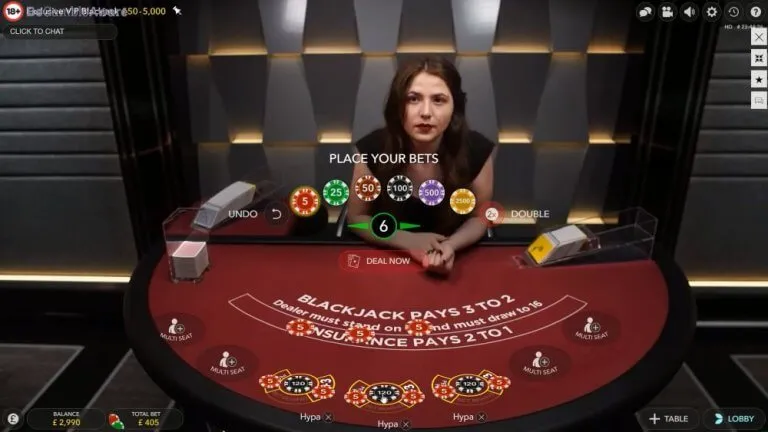 Screenshot of a live blackjack table screen with four numbered markers: 1 the card shoe, 2 the felt text Blackjack pays 3 to 2, 3 the felt text Dealer must stand on 17, 4 the Double button. The numbered list below explains each one.